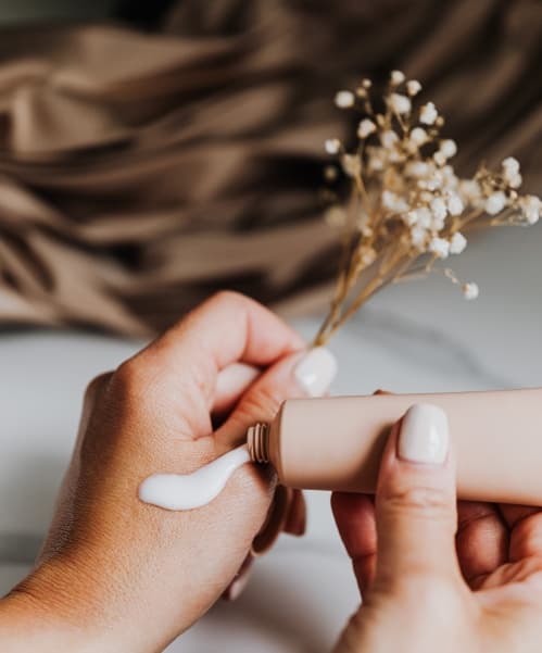 Hands holding a skincare product