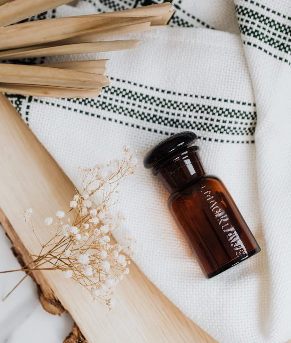 A brown bottle on a striped blanket